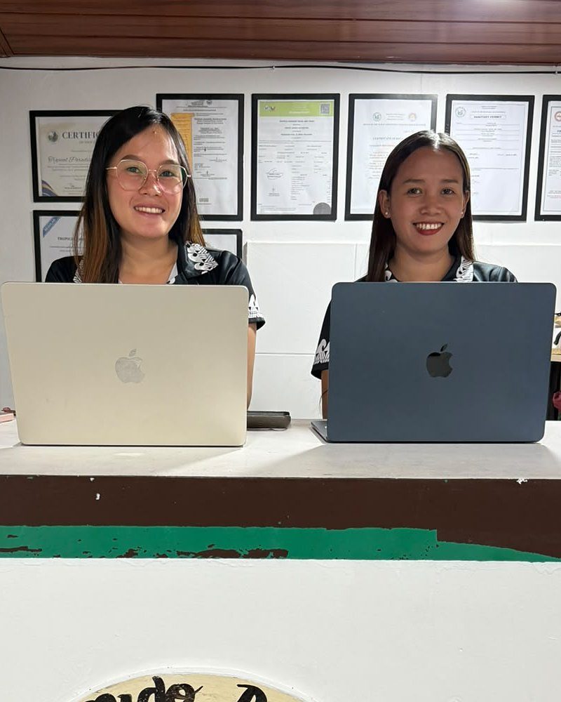 The Tropical Paradise office team at their desk in Palawan