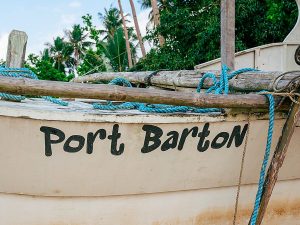 Bow of an expedition boat on calm water off Port Barton
